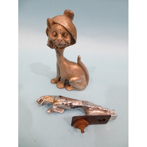 533 - A metal car mascot in the form of a seated smiling cat, wearing a bonnet tied with a bow under its c... 