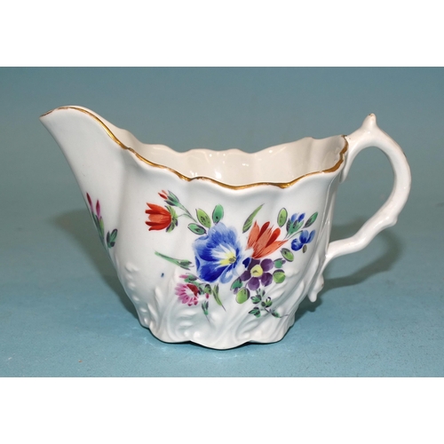 86 - A Worcester moulded flower-painted cream boat, 6.5cm high, 11cm long.