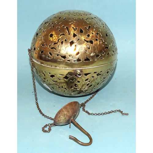 101 - An Eastern brass incense ball of hinged spherical form, pierced and engraved with flowers, foliate a... 