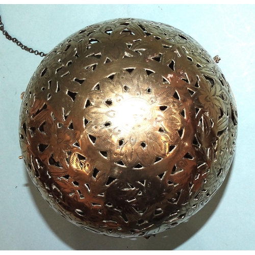 101 - An Eastern brass incense ball of hinged spherical form, pierced and engraved with flowers, foliate a... 