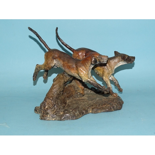 103 - Sally Rutherford (b.1940), a cold-painted bronze sculpture of two hounds leaping over a fallen tree ... 