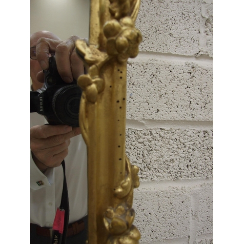 105 - A gilt wood wall mirror with carved foliate frame enclosing the later mirror plate, 75 x 62cm, (old ... 