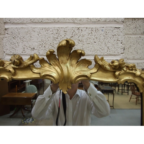 105 - A gilt wood wall mirror with carved foliate frame enclosing the later mirror plate, 75 x 62cm, (old ... 