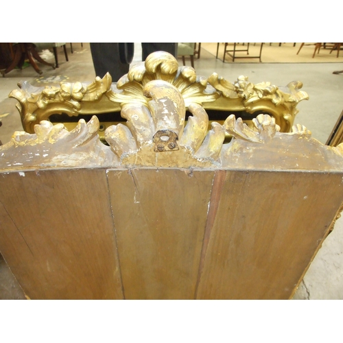 105 - A gilt wood wall mirror with carved foliate frame enclosing the later mirror plate, 75 x 62cm, (old ... 