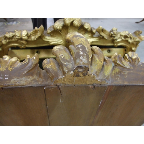 105 - A gilt wood wall mirror with carved foliate frame enclosing the later mirror plate, 75 x 62cm, (old ... 