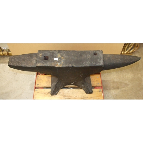 109 - A large vintage cast iron blacksmith's anvil, 95cm long, 32cm high.