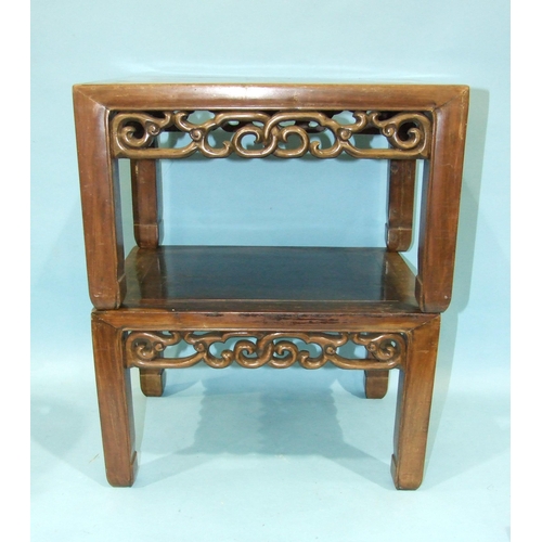 12 - A pair of Chinese hardwood rectangular low occasional tables with pierced frieze, on square shaped l... 