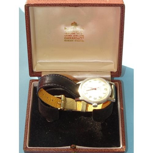 140 - Garrard, a gentleman's steel-cased manual wind wrist watch, the silvered dial with Arabic numerals, ... 