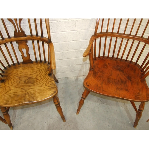 15 - A pair of elm and beech comb-back Windsor chairs with crinoline stretchers and turned legs, (reddish... 