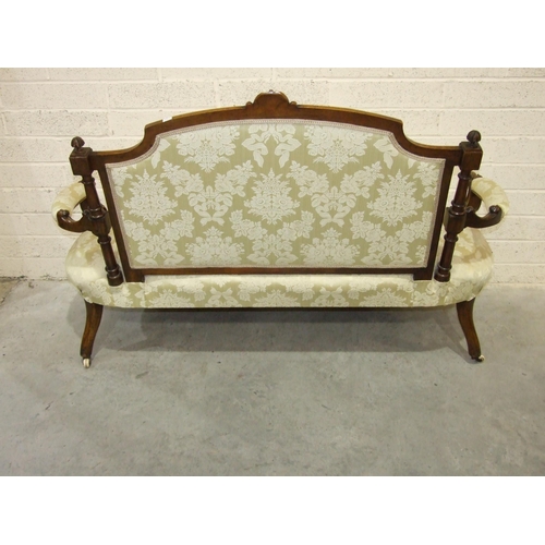 17 - A late-Victorian walnut drawing room settee, the carved and upholstered back to scroll open arms and... 