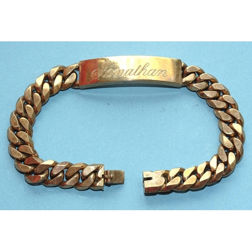 239 - A 9ct gold curb-link identity bracelet with concealed clasp, 21cm, 63.7g.