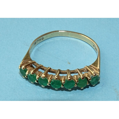 271 - An emerald half-hoop ring claw-set seven round-cut emeralds, in 9ct gold mount, size R, 2.2g.... 