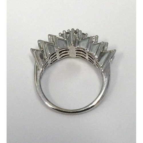 286 - An unusual diamond cluster ring claw-set a central cluster of nine brilliant-cut diamonds between th... 