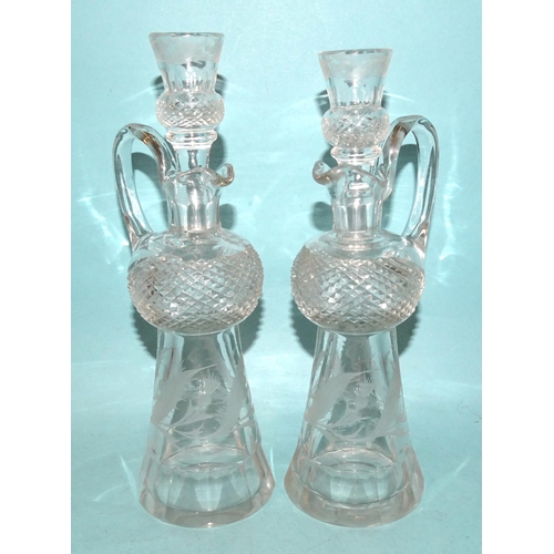 85 - A pair of cut-glass and etched thistle-shaped decanters and stoppers, the stoppers with tot finials,... 