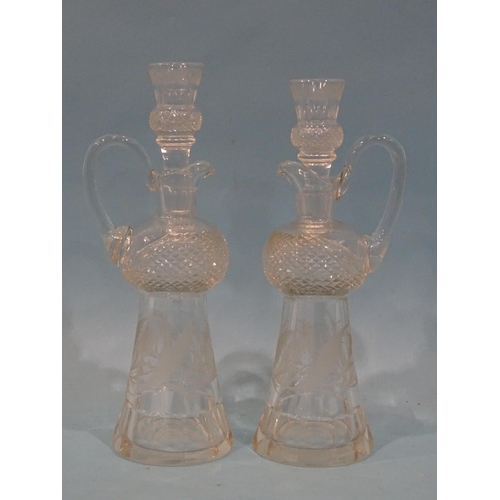 85 - A pair of cut-glass and etched thistle-shaped decanters and stoppers, the stoppers with tot finials,... 