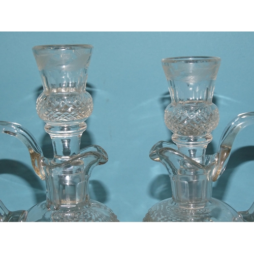 85 - A pair of cut-glass and etched thistle-shaped decanters and stoppers, the stoppers with tot finials,... 