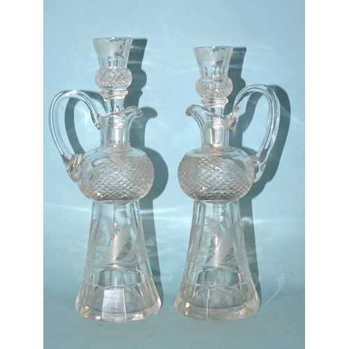 85 - A pair of cut-glass and etched thistle-shaped decanters and stoppers, the stoppers with tot finials,... 