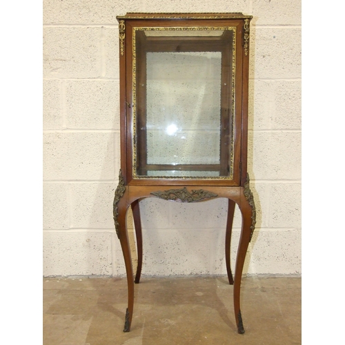 9 - A 19th century Continental four-sided glazed display cabinet on cabriole legs, with overall gilt met... 