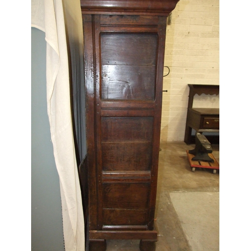 18 - A large antique oak two-door food cupboard, with later cornice above a pair of carved panelled doors... 