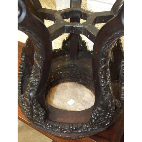 6 - A Chinese carved hardwood plant stand with raised inset marble top, on five shaped and carved legs, ... 