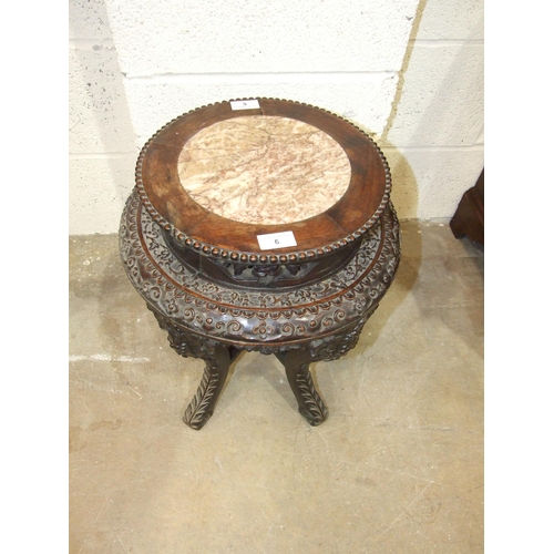 6 - A Chinese carved hardwood plant stand with raised inset marble top, on five shaped and carved legs, ... 