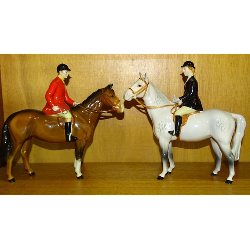 145 - A Beswick Huntsman on brown gloss horse and a Beswick Huntswoman on grey gloss horse, both 21.5cm hi... 