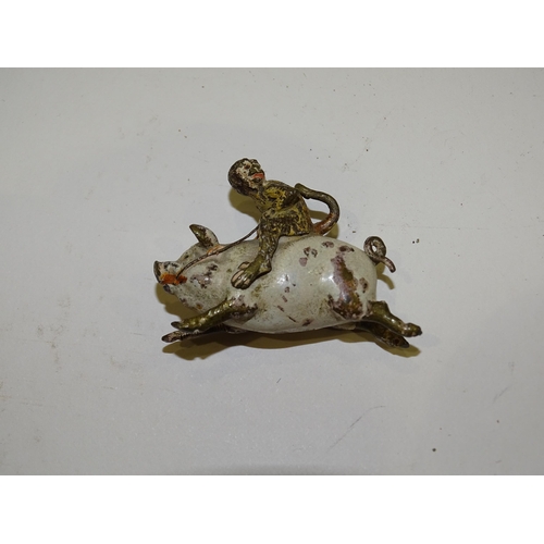 193 - A miniature cold painted bronze figure of a monkey riding a pig, 3cm high, 4cm long, a pair of metal... 