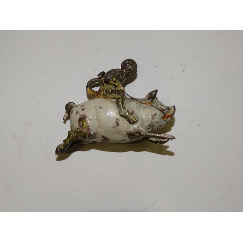 193 - A miniature cold painted bronze figure of a monkey riding a pig, 3cm high, 4cm long, a pair of metal... 