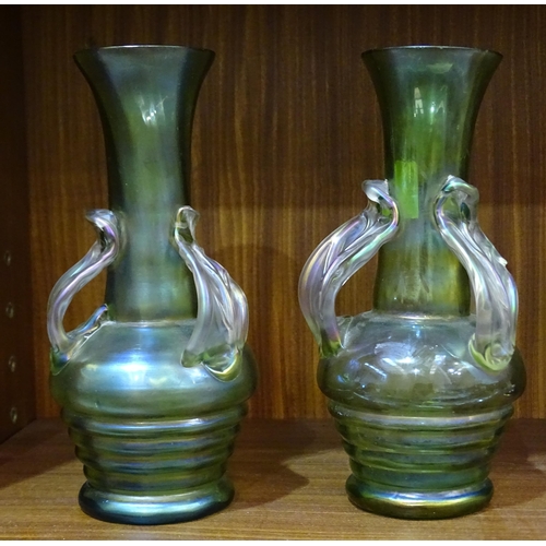 82 - A pair of Loetz-style green glass vases each with three applied leaf handles, 21cm high.... 