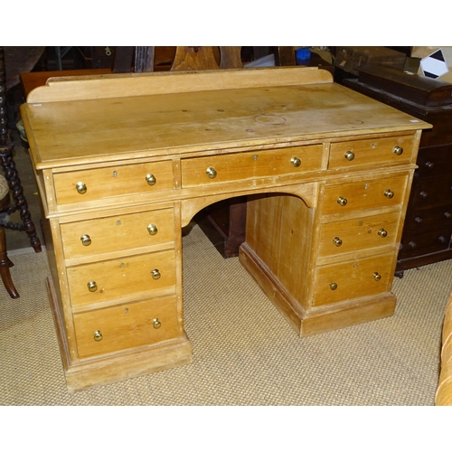 11 - A Victorian pine kneehole desk/dressing chest, having an arrangement of nine small drawers, 123cm wi... 