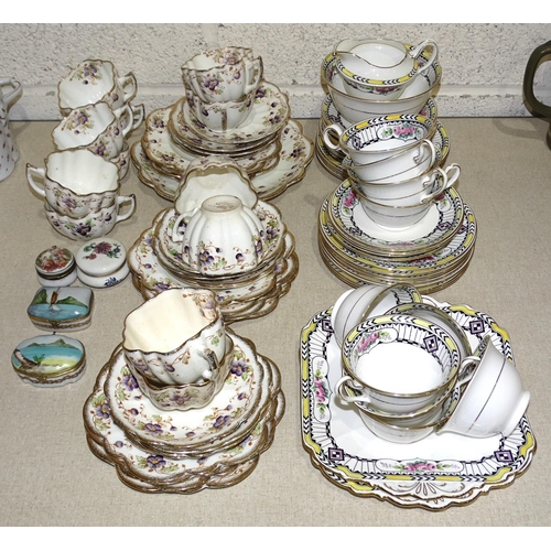 29 - A collection of Melba China teaware decorated with pansies, thirty-five pieces, (no visible cracks, ... 