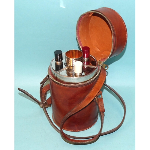 38 - A mid-20th century travelling spirit decanter set, containing three shaped flasks and four gilt-line... 