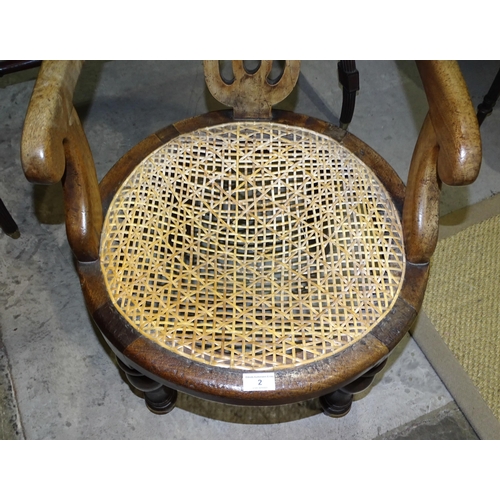 2 - A 19th century mahogany armchair with circular caned seat, on turned front legs, (caning stretched a... 