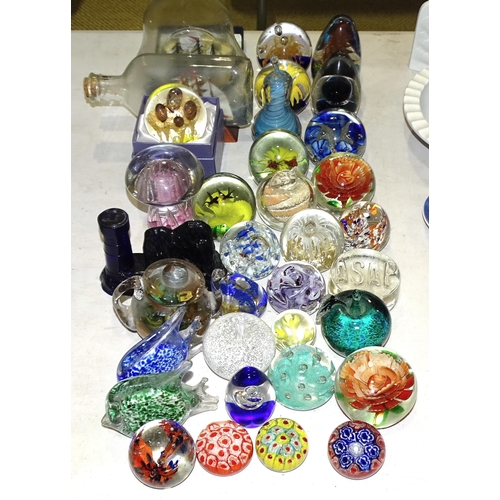 57 - A collection of modern paperweights, a ship in a bottle and other items.