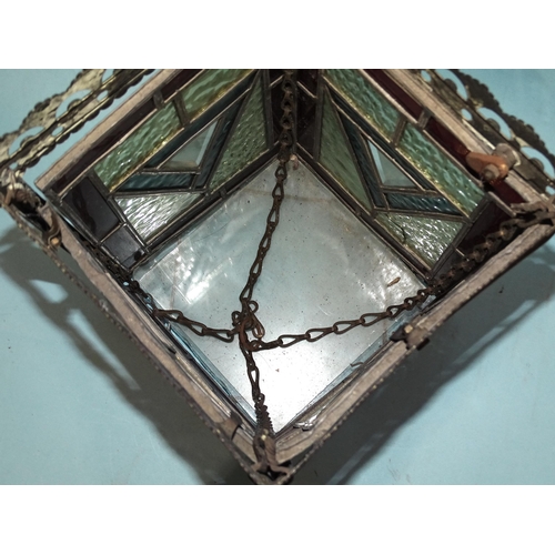 64 - An early-20th century hanging lantern of square form, with four multi-coloured leaded glazed panels,... 