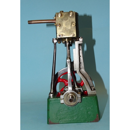 688 - A single-piston vertical stationary engine with flywheel, unmarked, 19.5cm.