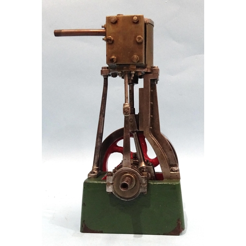 688 - A single-piston vertical stationary engine with flywheel, unmarked, 19.5cm.