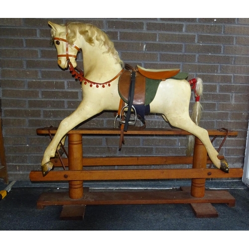 64 - A painted fibre glass rocking horse on pine trestle base, possibly by Haddon Rockers, with glass eye... 