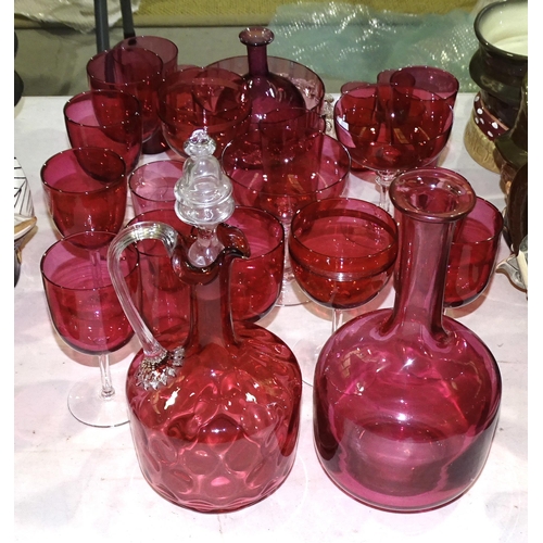 131 - A cranberry glass decanter, 27cm high, a circular frilled bowl and a collection of cranberry glasses... 