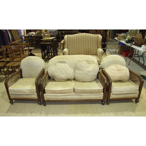 10 - A mid-20th century stained wood and caned Bergère suite, comprising a two-seater settee and t... 