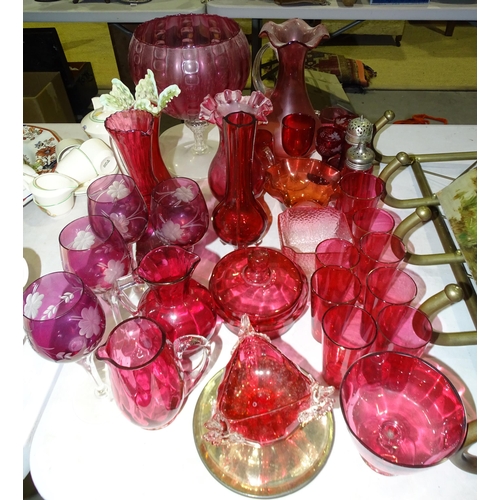 113 - A collection of cranberry glass beakers, jugs and other glassware.