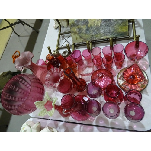 113 - A collection of cranberry glass beakers, jugs and other glassware.