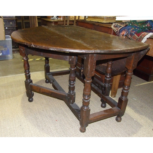 16 - An antique oak drop-leaf dining table, 122 x 132cm open.