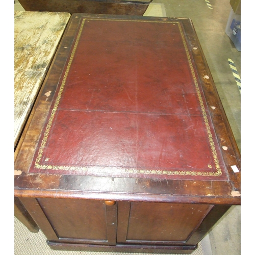 19 - A stained pine kneehole desk, the leather-inset top above a central drawer, eight pedestal drawers a... 