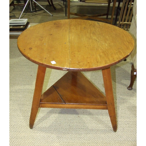 2 - A stained pine circular 'cricket' table, on three splayed legs joined by a triangular undertier, 76c... 