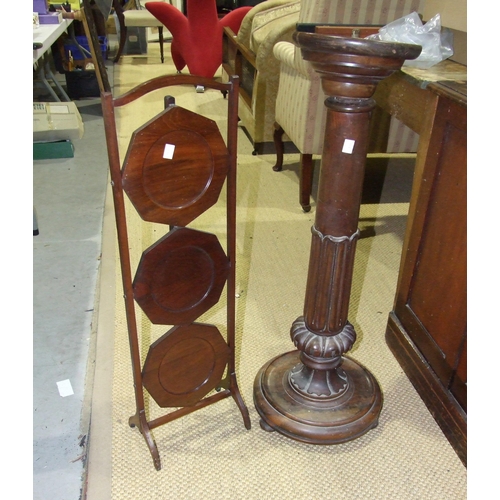 29 - A three-tier mahogany cake stand and an early-19th century rosewood torchère, (2).... 