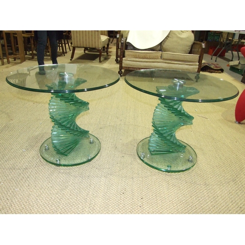8 - A pair of contemporary circular glass-topped occasional tables on stepped spiral bases, in the manne... 