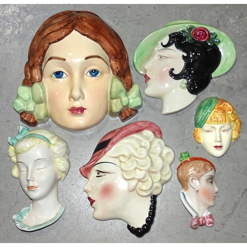 90 - A Beswick pottery face mask of a young girl with plaits, impressed 393, 20 x 20.5cm and five other s... 