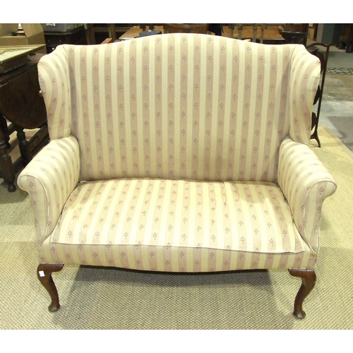 31 - A Georgian-style mahogany two-seater wing settee on cabriole front legs, 124cm wide.... 