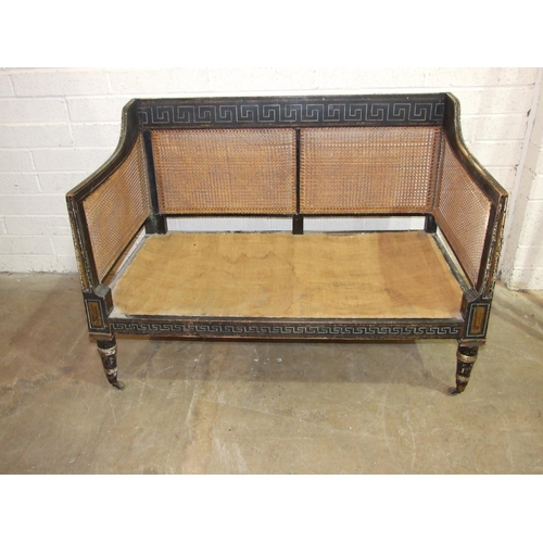 104 - A Regency caned Bergère settee with painted frame, on removeable turned legs with castors, 129cm wid... 